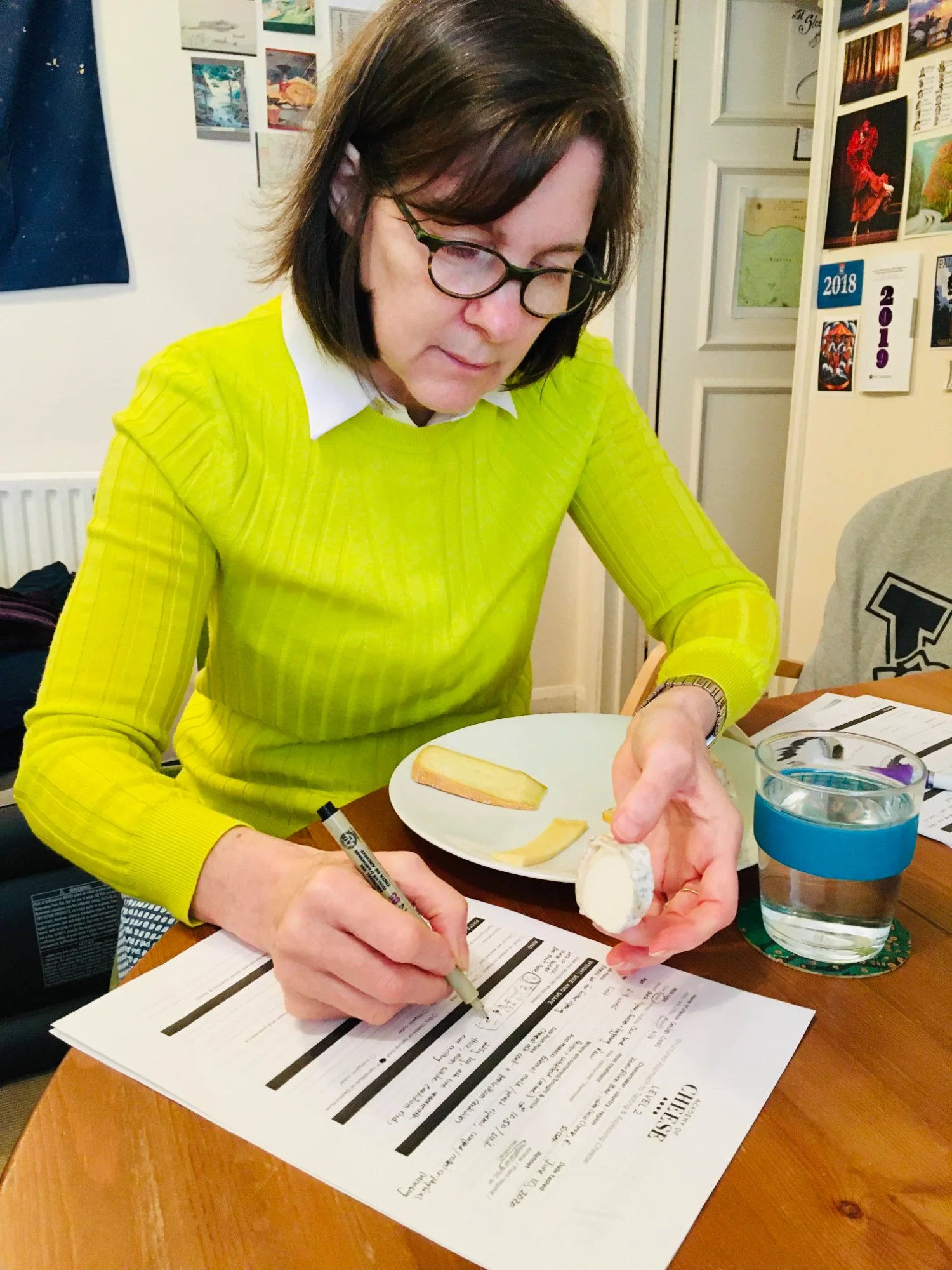 Sharon Ruwart at desk evaluating cheese